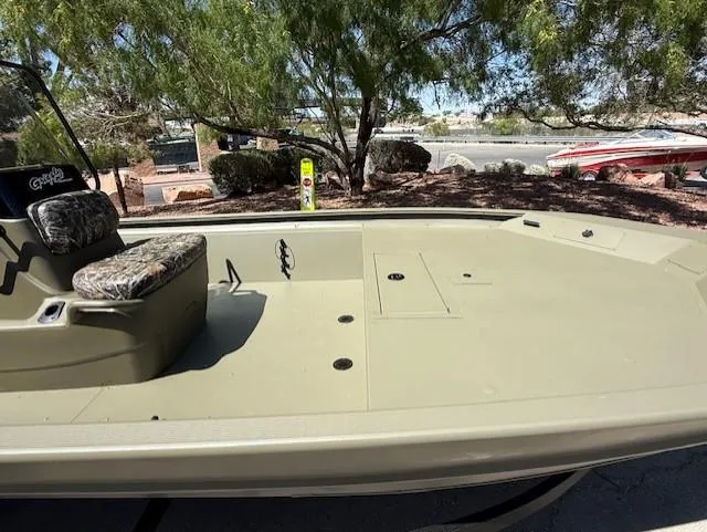 Slide: The Image of 2025 Tracker Grizzly 1860 CC boat, spacious deck, camo seat, outdoor setting. - 4
