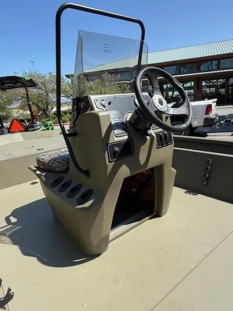 Slide: The Image of 2025 Tracker Grizzly 1860 CC boat console with steering wheel and controls. - 5