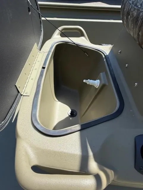 Slide: The Image of 2025 Tracker Grizzly 1860 CC boat interior with storage compartment and drain plug. - 7