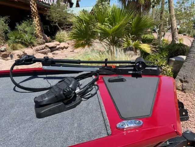 Slide: The Image of 2025 Tracker Pro 170 boat with Minn Kota trolling motor, red and gray deck, outdoor setting. - 6