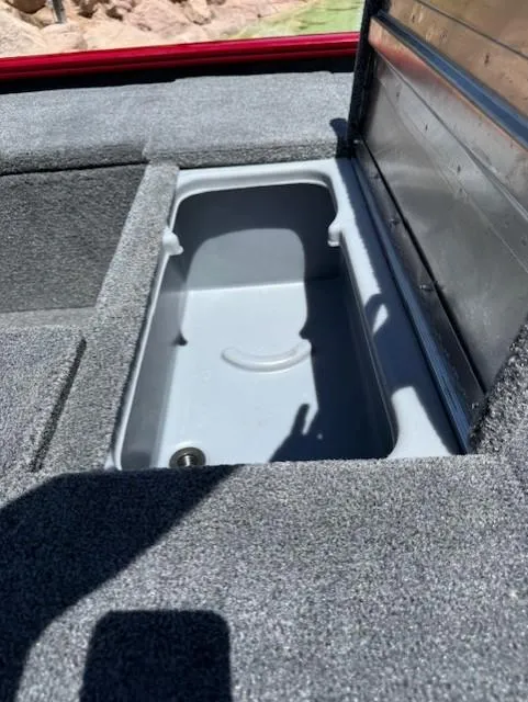 Slide: The Image of 2025 Tracker Pro 170 boat storage compartment with open lid, showcasing interior space. - 9