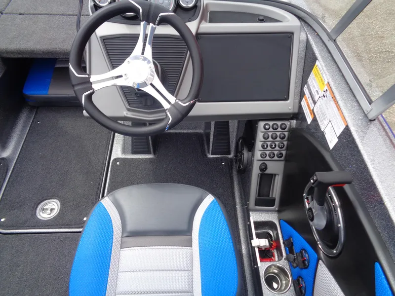 Slide: The Image of 2025 Ranger 1850MS boat cockpit with steering wheel, control panel, and blue-accented seat. - 14