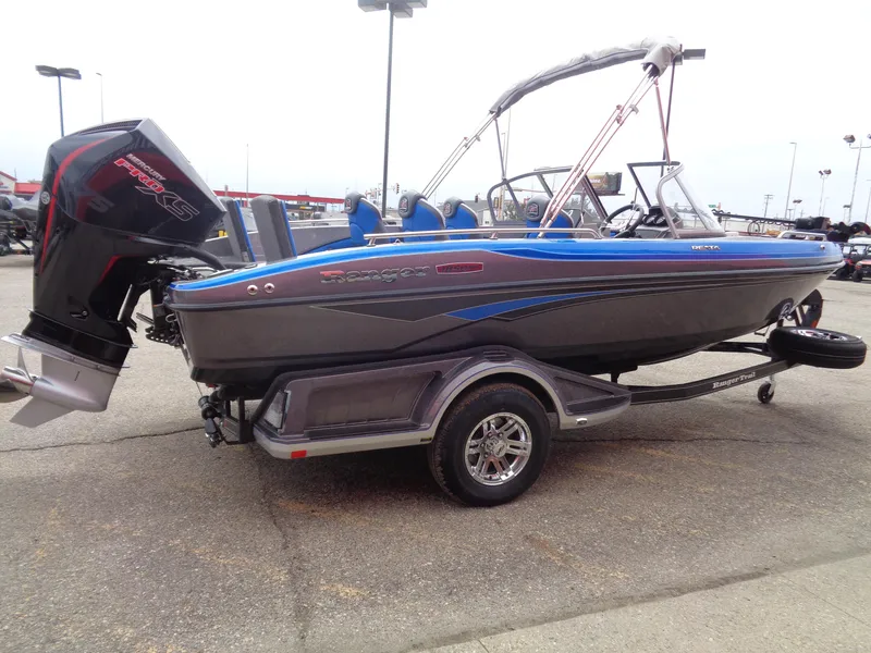 Slide: The Image of 2025 Ranger 1850MS boat with blue accents on a trailer, parked outdoors. - 3