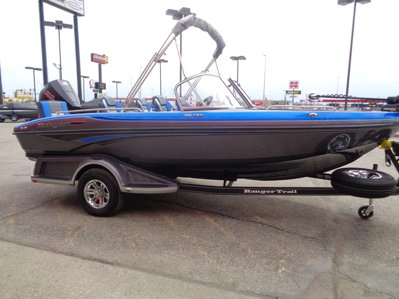 Slide: The Image of 2025 Ranger 1850MS boat on trailer, blue and black design, parked outdoors. - 5