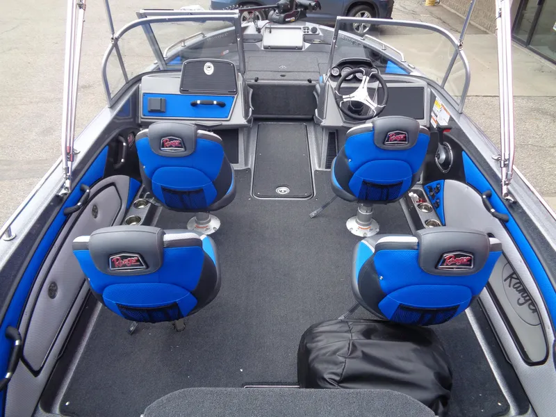 Slide: The Image of 2025 Ranger 1850MS boat interior with blue seats and modern dashboard. - 6