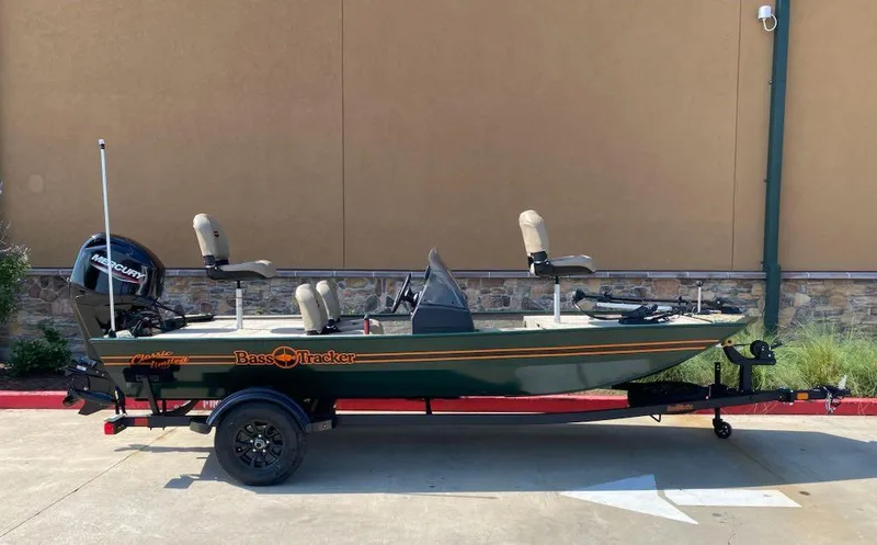 Slide: The Image of 2025 Tracker Bass Tracker Classic Limited boat on trailer, parked outdoors. - 2