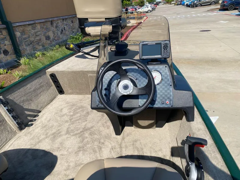 Slide: The Image of 2025 Tracker Bass Tracker Classic Limited boat dashboard with steering wheel and navigation system. - 5
