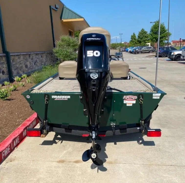Slide: The Image of 2025 Tracker Bass Tracker Classic Limited boat with Mercury 50 engine, parked outdoors. - 6