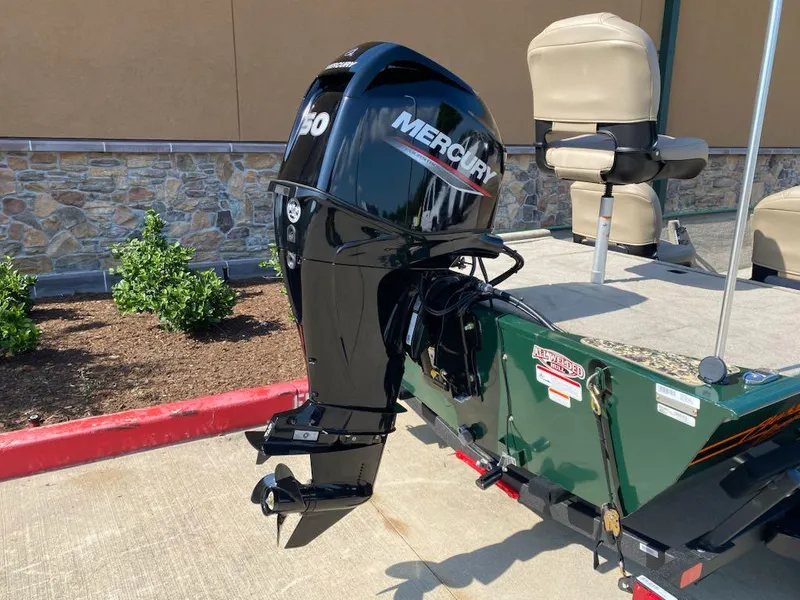 Slide: The Image of 2025 Tracker Bass Tracker Classic Limited boat with Mercury outboard motor, parked on concrete. - 7