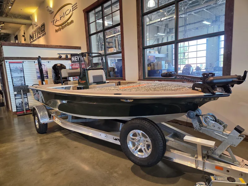 The Image of 2025 Mako 18 Pro Skiff Backwater Edition displayed in showroom on trailer. - 0