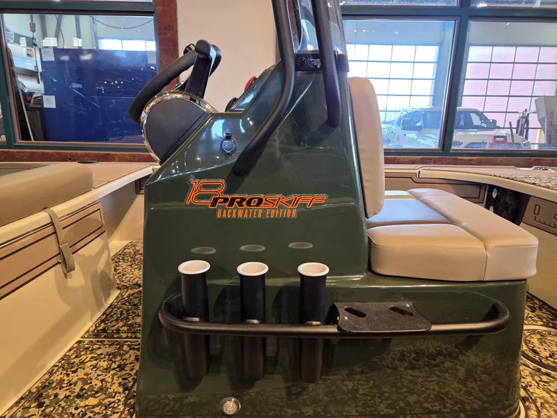 Slide: The Image of 2025 Mako 18 Pro Skiff Backwater Edition interior with steering console and seating. - 4