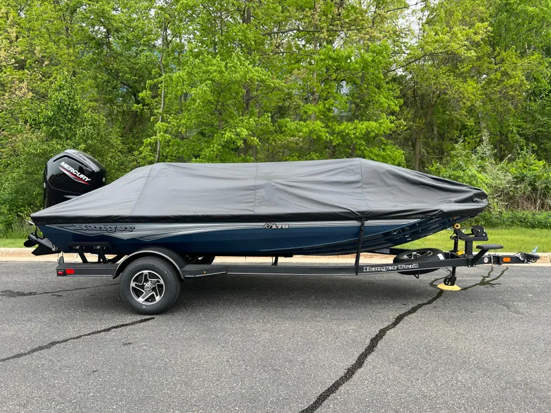 Slide: The Image of 2025 Ranger RT178 boat with Mercury engine on trailer, parked outdoors. - 1