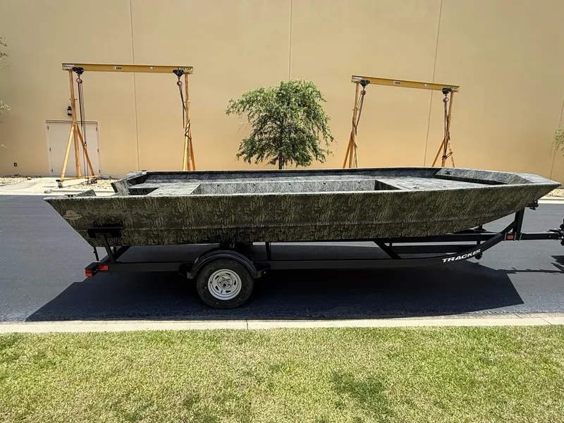 The Image of 2025 Tracker GRIZZLY 2072 Utility boat on trailer, parked outdoors. - 0