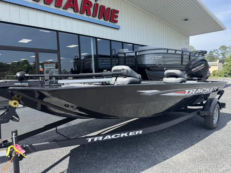 Slide: The Image of 2025 Tracker Panfish 17 boat on trailer outside marine store. - 3