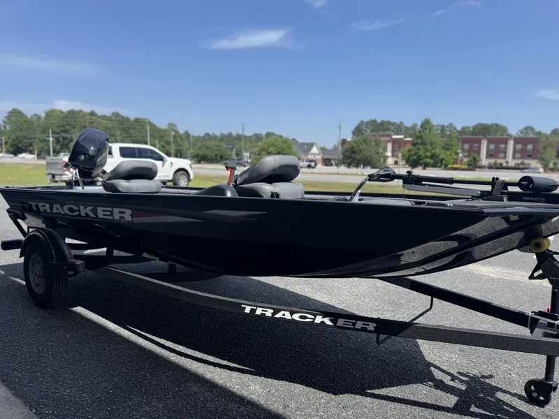 Slide: The Image of 2025 Tracker Panfish 17 boat on trailer, parked outdoors under clear sky. - 4