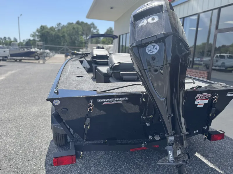 Slide: The Image of 2025 Tracker Panfish 17 boat with 40 HP motor, parked outdoors. - 5