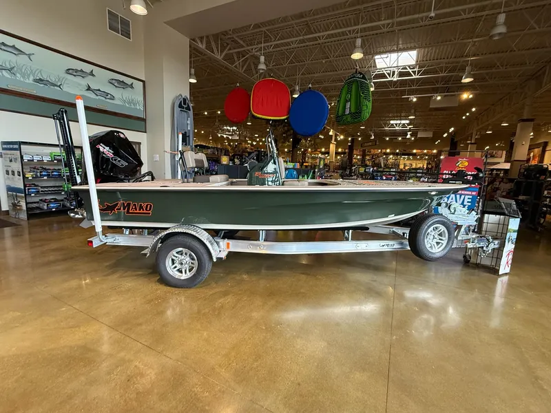 The Image of 2025 Mako 18 Pro Skiff Backwater Edition displayed in a showroom on a trailer. - 0