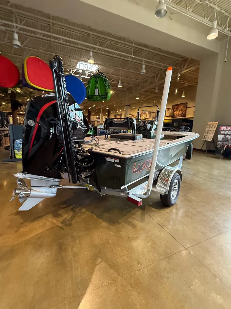 Slide: The Image of 2025 Mako 18 Pro Skiff Backwater Edition displayed indoors on a trailer. - 3