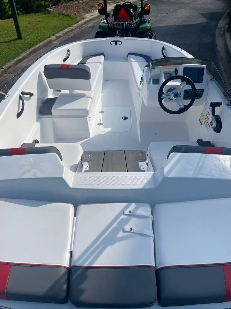 Slide: The Image of 2025 Tahoe T16 boat interior with seating and steering wheel, showcasing modern design. - 3