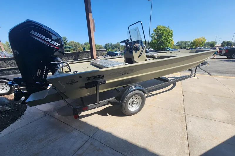 The Image of 2025 Tracker Grizzly 1860 CC boat on trailer with Mercury engine, parked outdoors. - 0