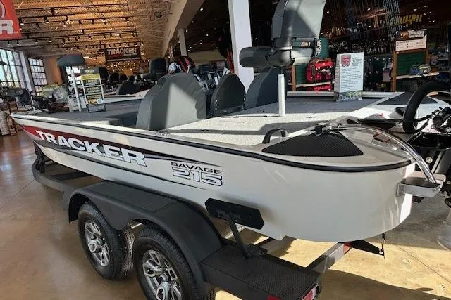 Slide: The Image of 2025 Tracker Savage 215 boat displayed indoors on a trailer. - 3
