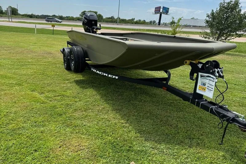 Slide: The Image of 2025 Tracker Grizzly 1650 T Prairie Wings Edition boat on trailer, parked on grass. - 2