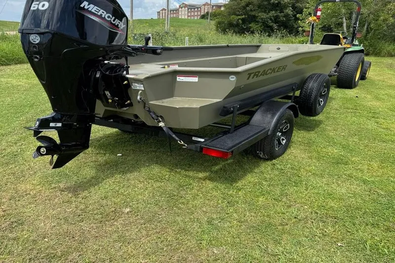 Slide: The Image of 2025 Tracker Grizzly 1650 T Prairie Wings Edition boat on trailer, with Mercury engine. - 3