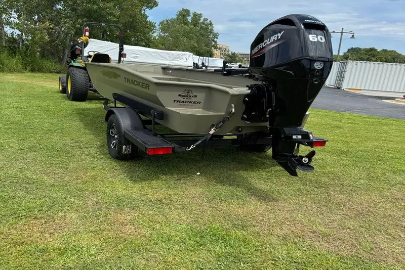 Slide: The Image of 2025 Tracker Grizzly 1650 T Prairie Wings Edition boat on trailer, grassy background. - 4