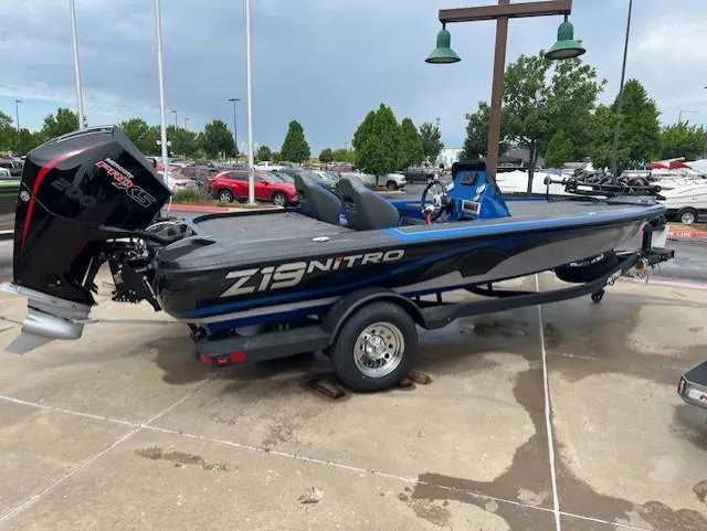 Slide: The Image of 2025 Nitro Z19 boat on trailer, parked outdoors, featuring sleek design and powerful engine. - 1