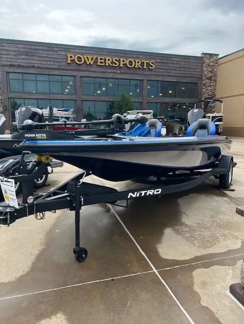 Slide: The Image of 2025 Nitro Z19 boat displayed outside Powersports store. - 2