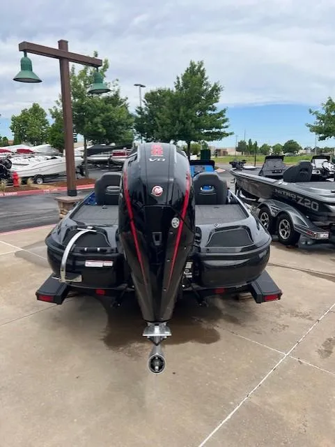Slide: The Image of 2025 Nitro Z19 boat, rear view, parked outdoors with other boats nearby. - 3