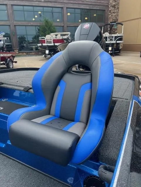 Slide: The Image of 2025 Nitro Z19 boat seat with blue and gray design, displayed outdoors. - 8