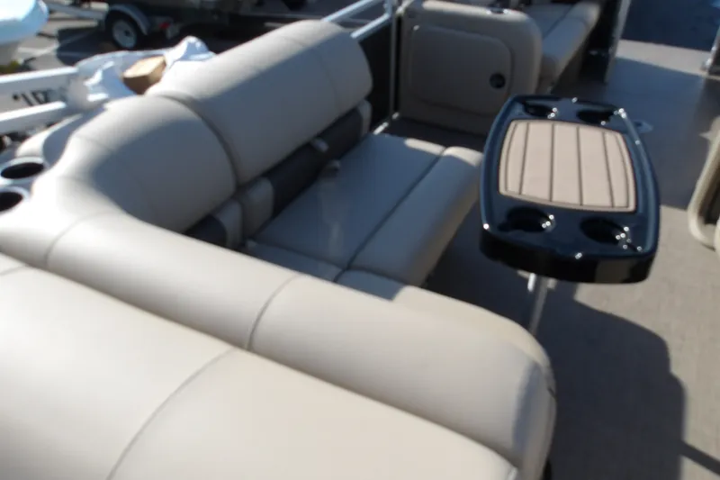 Slide: The Image of 2025 Sun Tracker Party Barge 22 RF DLX interior with plush seating and table. - 17