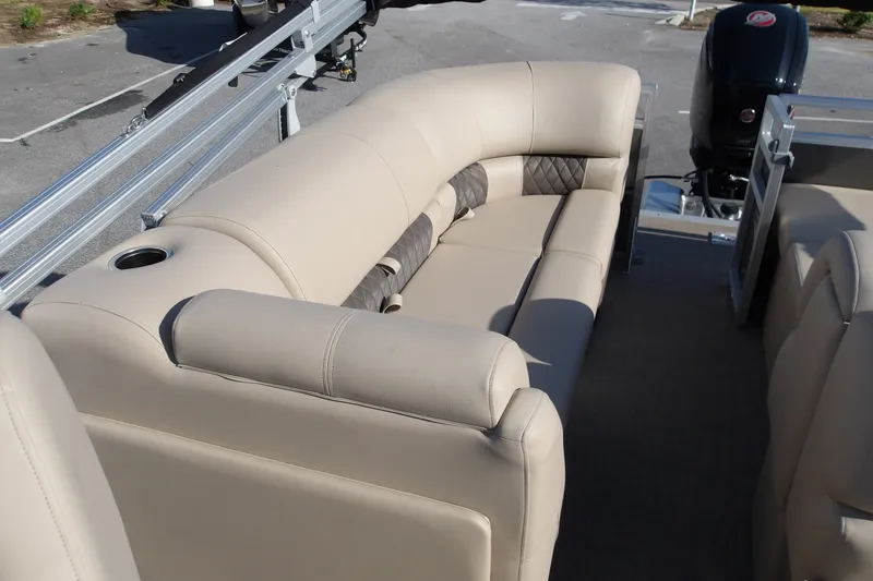 Slide: The Image of 2025 Sun Tracker Party Barge 22 RF DLX with beige seating and cup holder. - 15