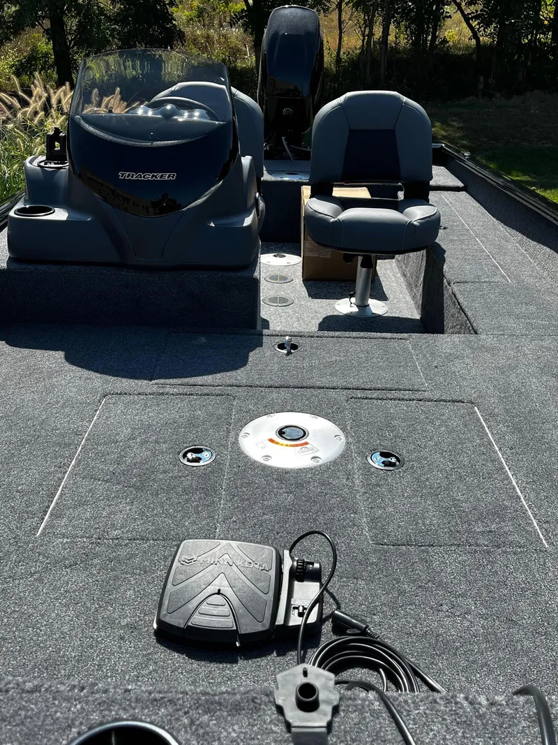 Slide: The Image of 2025 Tracker Super Guide V-16 SC boat interior with seating and control panel. - 3