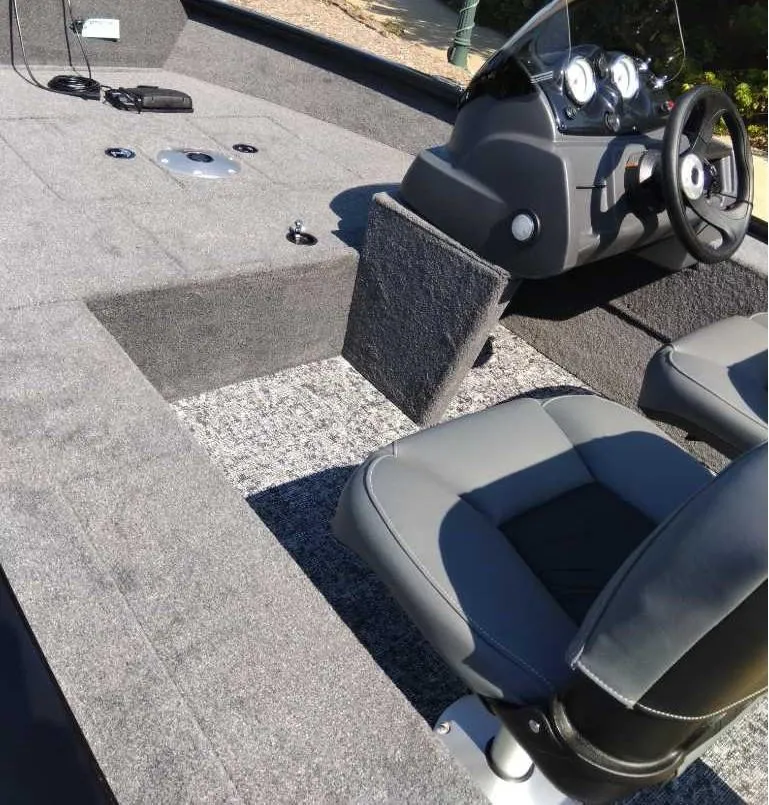 Slide: The Image of 2025 Tracker Super Guide V-16 SC boat interior with steering console and seating. - 4