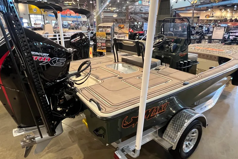 Slide: The Image of 2025 Mako 18 Pro Skiff Backwater Edition boat displayed in showroom with Mercury Pro XS engine. - 2