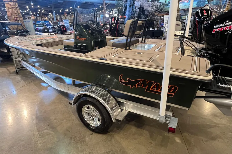 Slide: The Image of 2025 Mako 18 Pro Skiff Backwater Edition on display in a showroom. - 6