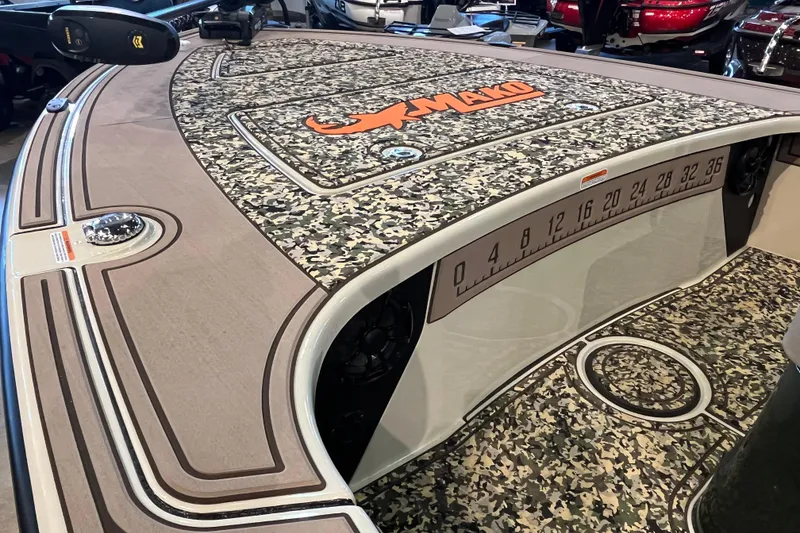 Slide: The Image of 2025 Mako 18 Pro Skiff Backwater Edition with camo deck and measurement markings. - 8