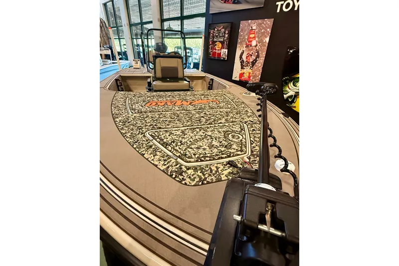 Slide: The Image of 2025 Mako 18 Pro Skiff Backwater Edition boat with camo deck in showroom display. - 12