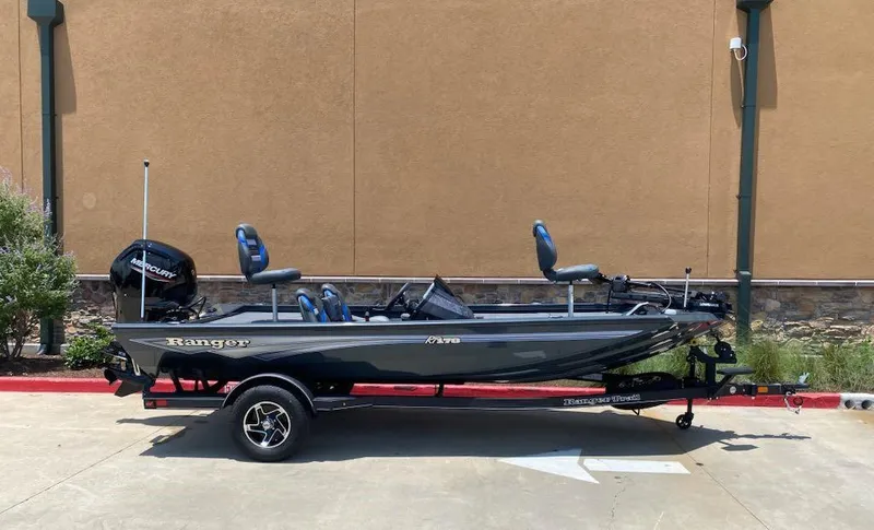 Slide: The Image of 2025 Ranger RT178 fishing boat on trailer, parked outdoors. - 2