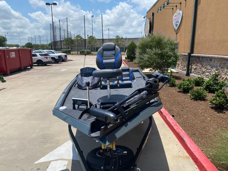 Slide: The Image of 2025 Ranger RT178 boat parked outdoors on a sunny day. - 3