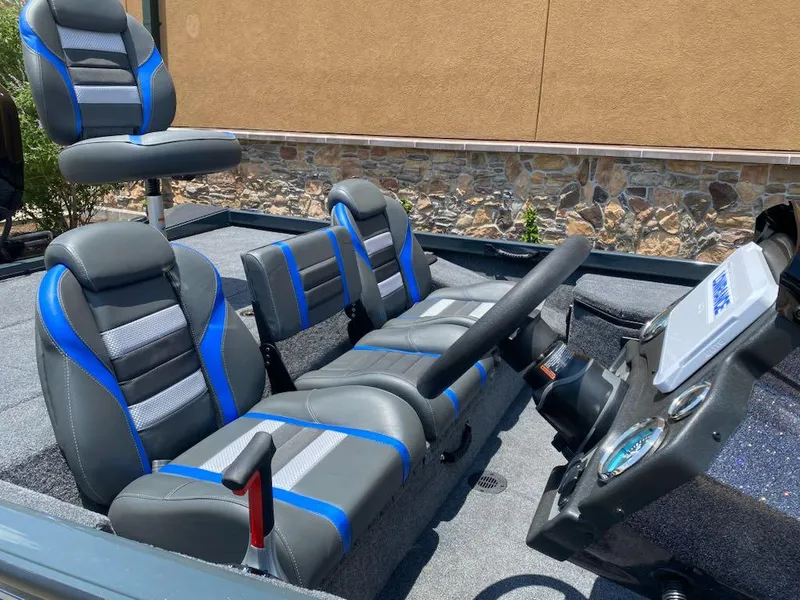 Slide: The Image of 2025 Ranger RT178 boat interior with blue and gray seating and steering console. - 5