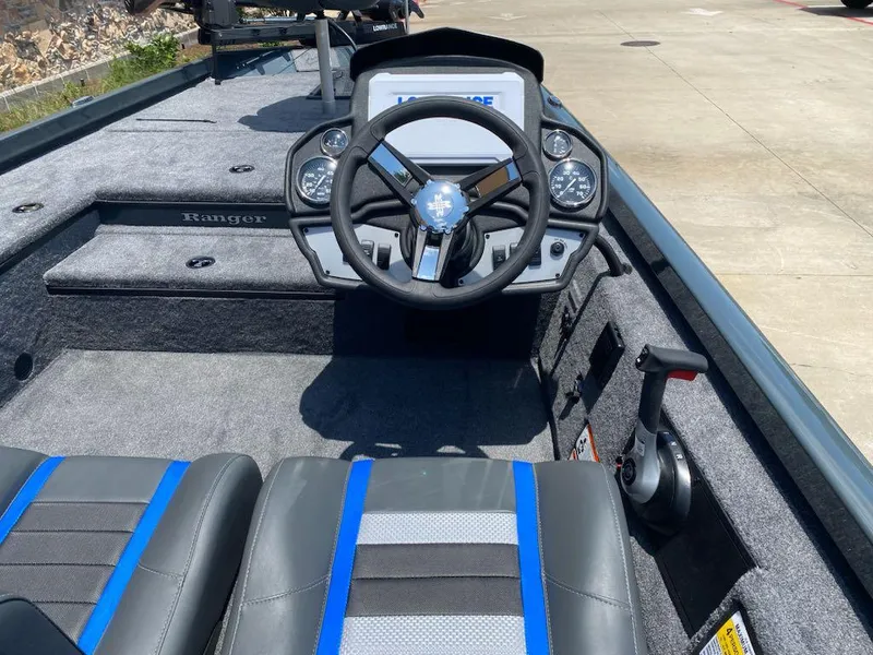 Slide: The Image of 2025 Ranger RT178 boat interior with steering wheel and dashboard, featuring blue-accented seats. - 6