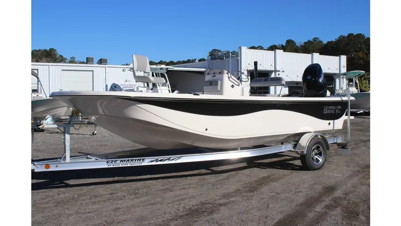 The Image of 2025 Carolina Skiff 21 LS boat on trailer, parked outdoors. - 0