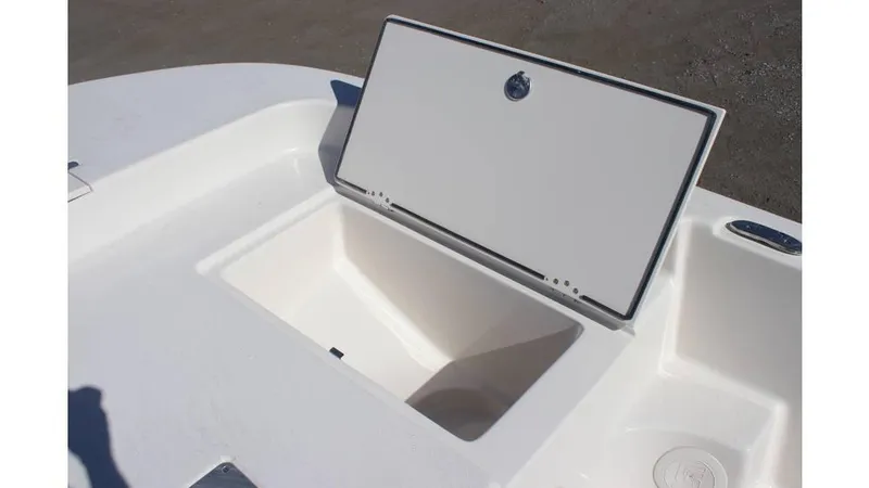 Slide: The Image of 2025 Carolina Skiff 21 LS boat storage compartment with open lid, showcasing spacious interior. - 10