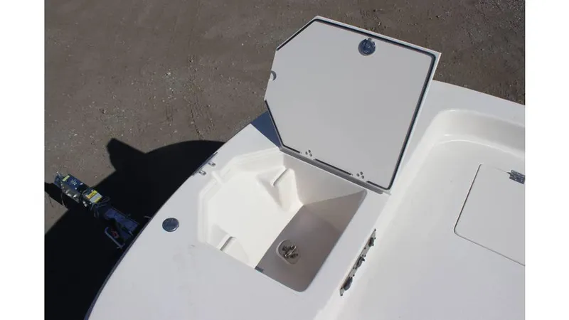 Slide: The Image of 2025 Carolina Skiff 21 LS boat storage compartment open on deck. - 11