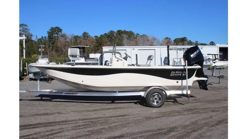 Slide: The Image of 2025 Carolina Skiff 21 LS boat on trailer, parked outdoors. - 16
