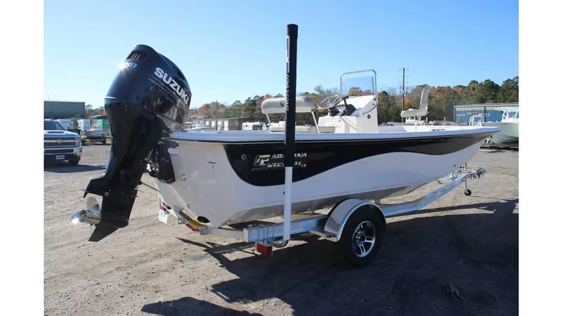 Slide: The Image of 2025 Carolina Skiff 21 LS boat on trailer with Suzuki outboard motor. - 2