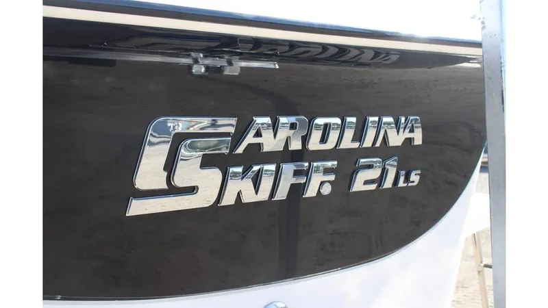 Slide: The Image of 2025 Carolina Skiff 21 LS boat logo on black hull. - 6